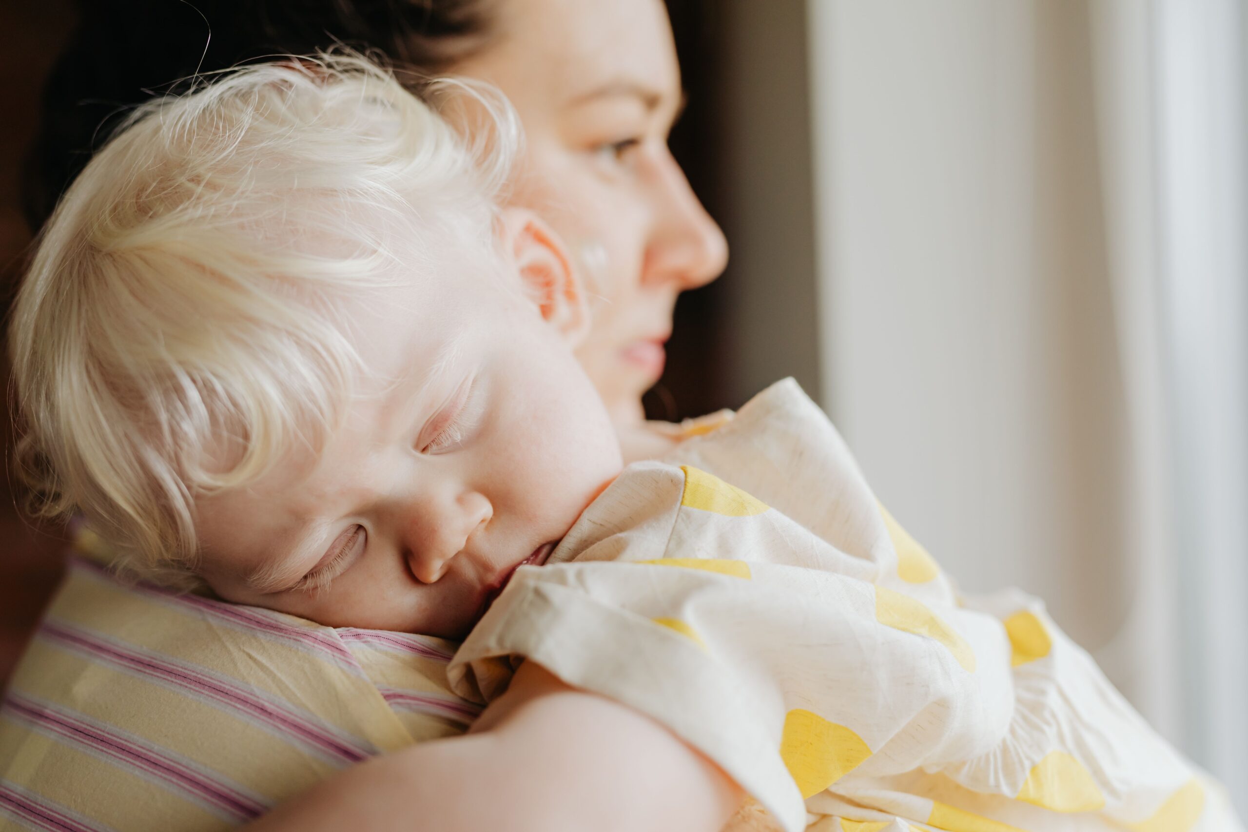 Baby napping in mom's arms