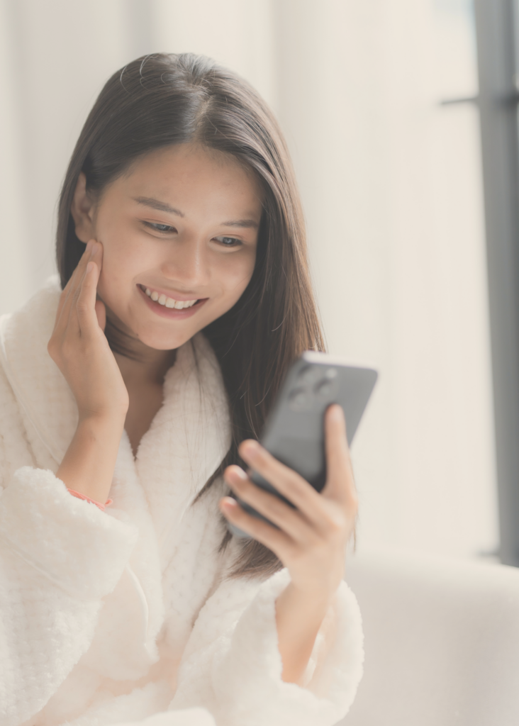 Women in spa robe using digital meditation app