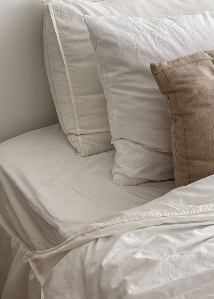 White and Beige Pillows on Bed